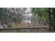 A wooden deck overlooks a serene lake surrounded by moss-draped trees, offering a tranquil outdoor space at 1030 Waccamaw Lake Dr., Conway, SC 29526