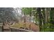 Backyard overlooking a serene lake, complemented by mature trees and a wooded landscape at 1030 Waccamaw Lake Dr., Conway, SC 29526