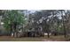 Exterior view of elevated home with surrounding lush trees and established landscaping at 1030 Waccamaw Lake Dr., Conway, SC 29526
