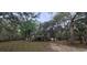 Exterior view of elevated home surrounded by lush trees and natural landscaping at 1030 Waccamaw Lake Dr., Conway, SC 29526