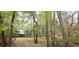 Exterior view of a charming home nestled among the trees, showcasing its peaceful setting at 1030 Waccamaw Lake Dr., Conway, SC 29526