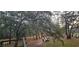Overlooking a tree-lined yard with moss-covered trees with a tranquil lake view from the back deck at 1030 Waccamaw Lake Dr., Conway, SC 29526