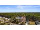 Property aerial view showcases a home nestled among mature trees and green landscaping at 1068 Harbor Dr., Calabash, NC 28467