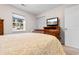 Comfortable bedroom with a bed, TV, natural light, and closet at 1068 Harbor Dr., Calabash, NC 28467