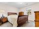 Inviting bedroom with a comfortable bed, wood furniture, and natural light at 1068 Harbor Dr., Calabash, NC 28467