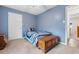 Blue bedroom with a ceiling fan, storage chest and single bed, providing a cozy and functional space at 1068 Harbor Dr., Calabash, NC 28467