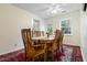 Bright dining room features a wooden table, chairs, red patterned rug and a ceiling fan at 1068 Harbor Dr., Calabash, NC 28467