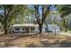 Classic single-story home with mature trees in the front yard, offering a serene setting at 1068 Harbor Dr., Calabash, NC 28467