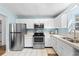 Functional kitchen space with white cabinetry and stainless steel appliances providing modern convenience at 1068 Harbor Dr., Calabash, NC 28467