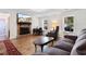 Inviting living room featuring wood floors, brick fireplace, comfortable seating and bright windows at 1068 Harbor Dr., Calabash, NC 28467