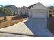 A one-story home showcases a driveway and a charming exterior with a palm tree in the front yard at 119 Ashworth Dr., Little River, SC 29566