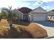 Charming one-story home featuring a two-car garage, well-maintained lawn, and a beautiful palm tree at 119 Ashworth Dr., Little River, SC 29566
