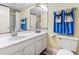 Well-lit bathroom featuring a white vanity, large mirror, toilet, and decorative towels at 1207 S Ocean Blvd. # 51006, Myrtle Beach, SC 29577