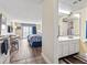 Bright bathroom featuring a vanity with storage and a large mirror, leading to an open bedroom/kitchenette at 1207 S Ocean Blvd. # 51006, Myrtle Beach, SC 29577