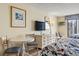 Relaxing bedroom with two beds, a dresser, and a bright painting on the wall at 1207 S Ocean Blvd. # 51006, Myrtle Beach, SC 29577