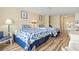 Comfortable bedroom showcasing two beds with floral bedding, plus kitchen and dining area at 1207 S Ocean Blvd. # 51006, Myrtle Beach, SC 29577