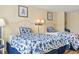 Inviting bedroom with two beds featuring blue floral comforters and decorative wall art at 1207 S Ocean Blvd. # 51006, Myrtle Beach, SC 29577