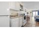 The kitchen features white appliances and overlooks an adjacent dining and bedroom area at 1207 S Ocean Blvd. # 51006, Myrtle Beach, SC 29577