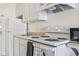 A clean kitchen features white appliances including a range and microwave at 1207 S Ocean Blvd. # 51006, Myrtle Beach, SC 29577