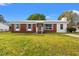 Charming single-story home with brick and vinyl siding, a metal roof, a well-maintained lawn, and gray shutters at 1287 Stalvey Ave., Myrtle Beach, SC 29577