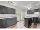 Stylish kitchen with gray cabinets, hardwood floors, stainless appliances, marble countertops, and lots of light at 1287 Stalvey Ave., Myrtle Beach, SC 29577