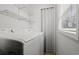 Functional laundry area with modern appliances, white wire shelving, and a window for natural light at 1287 Stalvey Ave., Myrtle Beach, SC 29577