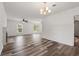 Open-concept living area with hardwood floors, a chandelier, a fireplace, and many bright windows at 1287 Stalvey Ave., Myrtle Beach, SC 29577