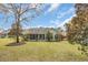 Well-manicured backyard with a screened porch and mature trees at 1292 Merion Ct., Murrells Inlet, SC 29576