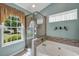 Beautiful bathroom with soaking tub and seamless glass shower, and an exterior view at 1292 Merion Ct., Murrells Inlet, SC 29576