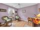 Bedroom with wicker chairs, wood floors, window with sheer curtains, and a desk at 1292 Merion Ct., Murrells Inlet, SC 29576