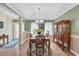 Elegant dining area featuring a tray ceiling, chandelier, and hardwood floors at 1292 Merion Ct., Murrells Inlet, SC 29576