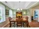Charming dining room featuring a tray ceiling, stylish chandelier, and views of the front yard at 1292 Merion Ct., Murrells Inlet, SC 29576