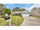 Charming home featuring a lush lawn, mature trees, and a convenient driveway leading to the attached garage at 1292 Merion Ct., Murrells Inlet, SC 29576