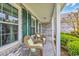 Inviting front porch with brick facade and two wicker chairs at 1292 Merion Ct., Murrells Inlet, SC 29576