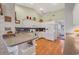 Bright kitchen features wood floors, white cabinets, breakfast bar, and modern appliances at 1292 Merion Ct., Murrells Inlet, SC 29576