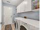 Laundry room with front-loading washer and dryer, and built-in white storage cabinets at 1292 Merion Ct., Murrells Inlet, SC 29576