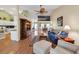 Open-concept living room with wood floors, bookshelves, and access to a kitchen and dining room at 1292 Merion Ct., Murrells Inlet, SC 29576