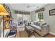 Cozy living room with plush sofa, wicker coffee table, and French doors to the patio at 1292 Merion Ct., Murrells Inlet, SC 29576