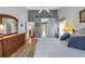Bright main bedroom featuring wood floors, blue accent pillows, and an ensuite bathroom at 1292 Merion Ct., Murrells Inlet, SC 29576