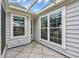 Enclosed patio with tile flooring, white siding, and plentiful windows at 1292 Merion Ct., Murrells Inlet, SC 29576