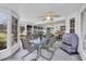 Bright sunroom featuring tile floors, ample windows, a grill and comfortable seating at 1292 Merion Ct., Murrells Inlet, SC 29576