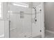 Modern bathroom featuring a walk-in shower with glass enclosure and marble tiling at 1312 Ashboro Ct., Myrtle Beach, SC 29579
