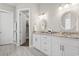 Bathroom with double vanity, granite countertop, decorative mirrors and an open doorway to a walk-in closet at 1312 Ashboro Ct., Myrtle Beach, SC 29579