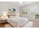 Staged bedroom featuring a large bed, nightstands and decorative wall art at 1312 Ashboro Ct., Myrtle Beach, SC 29579