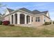 The brick exterior of the home has a covered porch with white pillars at 1312 Ashboro Ct., Myrtle Beach, SC 29579
