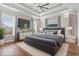 Main bedroom featuring a ceiling fan, tray ceiling, large windows, and neutral decor at 1312 Ashboro Ct., Myrtle Beach, SC 29579