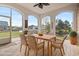 Enclosed porch featuring a ceiling fan, wooden table and chairs, with water view at 1312 Ashboro Ct., Myrtle Beach, SC 29579