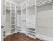 Spacious walk-in closet featuring custom shelving, drawers, and ample hanging space with hardwood floors at 1312 Ashboro Ct., Myrtle Beach, SC 29579