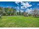 Large backyard with beautiful landscaping, mature trees, and well-maintained green grass at 144 Pink Dogwood Dr., Loris, SC 29569