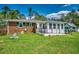 Expansive backyard featuring lush green grass, brick exterior, and a wooden deck perfect for outdoor enjoyment at 144 Pink Dogwood Dr., Loris, SC 29569